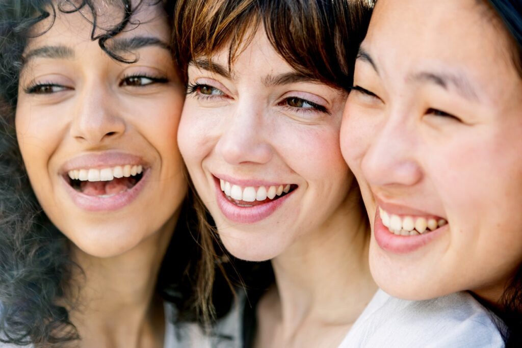 close up portrait of three young girls joining face