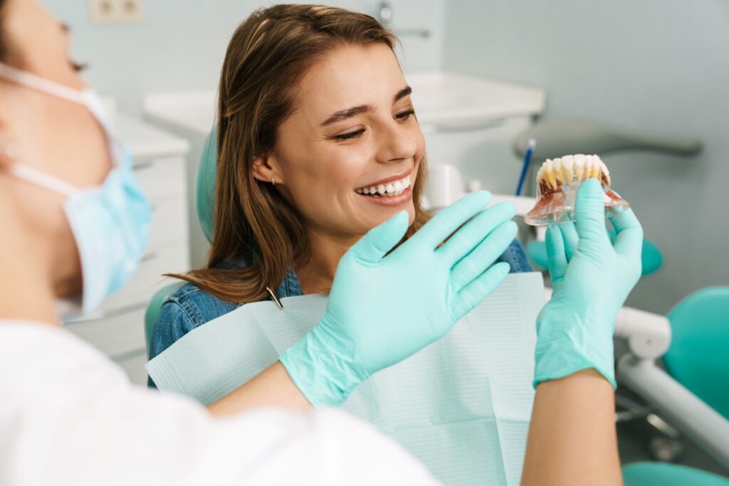 dentist woman showing teeth imitation