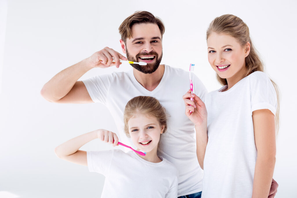 Family brushing their teeth together, representing preventive dental care at Gainesville Dental in Gainesville, TX.